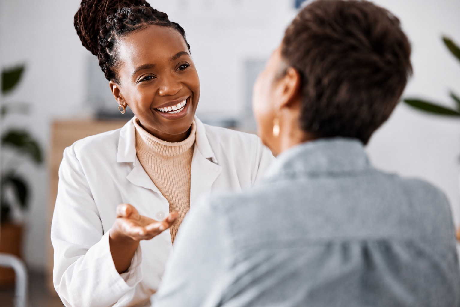 OB/GYN consulting a patient in an exam room