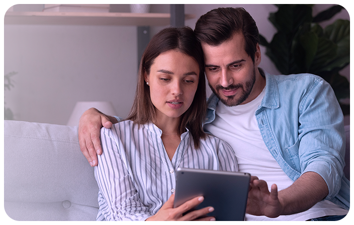 Couple reading Femasys content on a tablet